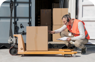 Order fulfillment employee inspecting label on cardboard box